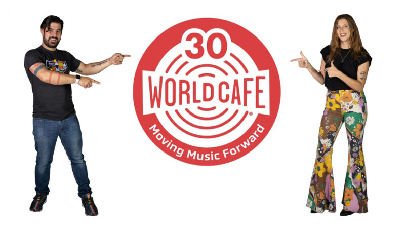 World Cafe hosts pointing at World Cafe logo